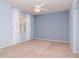 Serene bedroom with soft blue walls, a ceiling fan, and neutral carpeting for a cozy feel at 711 Planters Manor Way, Bradenton, FL 34212
