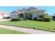 Inviting home showcasing green grass, trimmed hedges and a side entry garage at 711 Planters Manor Way, Bradenton, FL 34212