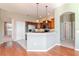 The kitchen features stainless steel appliances, wooden cabinets, and a breakfast bar at 711 Planters Manor Way, Bradenton, FL 34212