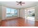 Bright living room featuring hardwood floors and a large window with scenic lake view at 711 Planters Manor Way, Bradenton, FL 34212