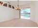 Living room with carpet flooring and a beautiful view of the lake and screened-in pool at 711 Planters Manor Way, Bradenton, FL 34212