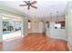 Spacious living room boasts beautiful floors and sliding glass doors to the outdoor pool area at 711 Planters Manor Way, Bradenton, FL 34212