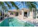 Screened pool area with a view into the home's interior and a glimpse of the kitchen at 711 Planters Manor Way, Bradenton, FL 34212