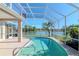 View of a sparkling pool with a screened enclosure and beautiful lake scenery at 711 Planters Manor Way, Bradenton, FL 34212