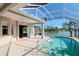 A view of an inviting pool within a screened enclosure overlooking a tranquil lake at 711 Planters Manor Way, Bradenton, FL 34212