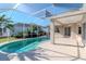 Screened in pool area with an outdoor fan and covered patio space to relax at 711 Planters Manor Way, Bradenton, FL 34212