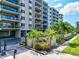 Exterior of 755 building with palm trees and blue glass balcony railings at 755 S Palm Avenue # 604, Sarasota, FL 34236