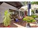 Cozy outdoor seating at ofKors Bakery with vibrant floral planters and inviting atmosphere at 755 S Palm Avenue # 604, Sarasota, FL 34236