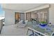 Comfortable condo balcony with outdoor lounge chairs and an ocean view through the sliding glass doors at 755 S Palm Avenue # 604, Sarasota, FL 34236