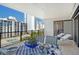 Outdoor dining area overlooking a pool, with city views, on a sunny, covered balcony at 755 S Palm Avenue # 604, Sarasota, FL 34236