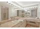 Bright bathroom with marble countertop, large mirror, vanity lighting, and a dedicated makeup area with stool at 755 S Palm Avenue # 604, Sarasota, FL 34236