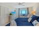 Bedroom with bay window, water view, and neutral color scheme at 755 S Palm Avenue # 604, Sarasota, FL 34236