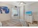 Bright bedroom featuring a television, a large bed, an abstract painting, and a view through the window at 755 S Palm Avenue # 604, Sarasota, FL 34236