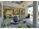 Stylish building entrance with a water feature, plants, and modern glass doors at 755 S Palm Avenue # 604, Sarasota, FL 34236