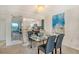 Stylish dining area with modern art, a decorative light fixture, and an adjacent kitchen at 755 S Palm Avenue # 604, Sarasota, FL 34236