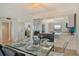 Dining room featuring a glass table set for dinner, with an adjacent living area and kitchen at 755 S Palm Avenue # 604, Sarasota, FL 34236