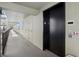 Hallway elevator with white walls, light fixtures, and an elevator sign, indicating stairwell location at 755 S Palm Avenue # 604, Sarasota, FL 34236