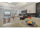 Bright kitchen features granite counters, stainless appliances, and black tiled backsplash at 755 S Palm Avenue # 604, Sarasota, FL 34236