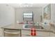 Bright kitchen features granite counters, stainless appliances, and modern faucet at 755 S Palm Avenue # 604, Sarasota, FL 34236