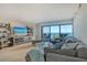 Cozy living room with a large window showcasing beautiful bay views and natural light at 755 S Palm Avenue # 604, Sarasota, FL 34236