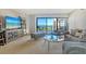 Comfortable living room featuring a large window with stunning water views and stylish furnishings at 755 S Palm Avenue # 604, Sarasota, FL 34236