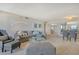 A contemporary living area with plush seating, a modern lamp, and an adjacent dining space at 755 S Palm Avenue # 604, Sarasota, FL 34236