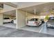 Parking space with a variety of cars, enclosed in a well-lit, covered structure at 755 S Palm Avenue # 604, Sarasota, FL 34236