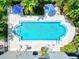 Aerial view of community pool with ample seating surrounded by lush greenery at 755 S Palm Avenue # 604, Sarasota, FL 34236