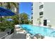 Beautiful community pool surrounded by tropical landscaping at 755 S Palm Avenue # 604, Sarasota, FL 34236