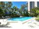 Enjoy the community pool, with chairs and tables, perfect for relaxing and soaking up the sun at 755 S Palm Avenue # 604, Sarasota, FL 34236