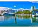 Waterfront view of a private yacht docked alongside waterfront buildings under a bright, sunny sky at 755 S Palm Avenue # 604, Sarasota, FL 34236