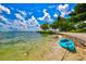 A kayak sits on a sandy waterfront with views of tranquil waters at 755 S Palm Avenue # 604, Sarasota, FL 34236