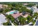 Aerial view showcasing the community pool, playground, and surrounding community at 7783 Limestone Ln # 10-101, Sarasota, FL 34233