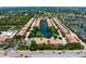 Aerial view of condominiums surrounding a landscaped pond with water features at 7783 Limestone Ln # 10-101, Sarasota, FL 34233