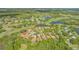 Aerial view of homes nestled in a golf course community near a lake and lush greenery at 7847 Chick Evans Pl, Sarasota, FL 34240
