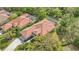 Aerial view of a home showcasing its tiled roof, screened pool, and well-manicured landscaping at 7847 Chick Evans Pl, Sarasota, FL 34240