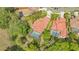 An aerial view showcases the home with a pool and lush landscaping in a desirable neighborhood at 7847 Chick Evans Pl, Sarasota, FL 34240