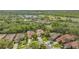 Aerial shot shows tile roof with mature trees and landscaping at 7847 Chick Evans Pl, Sarasota, FL 34240