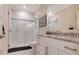 Elegant bathroom with white subway tile shower, glass door, and granite countertop vanity at 7847 Chick Evans Pl, Sarasota, FL 34240