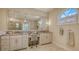 Bathroom vanity featuring double sinks, granite countertop, and arched window at 7847 Chick Evans Pl, Sarasota, FL 34240