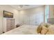 Comfortable bedroom with neutral decor, ceiling fan, and bright windows at 7847 Chick Evans Pl, Sarasota, FL 34240