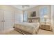 Comfortable bedroom with neutral decor, ceiling fan, and bright windows at 7847 Chick Evans Pl, Sarasota, FL 34240