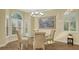 Charming dining room featuring hardwood floors and shuttered windows for natural light at 7847 Chick Evans Pl, Sarasota, FL 34240