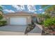 Well maintained property showing garage, landscape, and sidewalk at 7847 Chick Evans Pl, Sarasota, FL 34240
