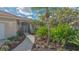 Pathway leads to the entrance surrounded by lush landscaping at 7847 Chick Evans Pl, Sarasota, FL 34240