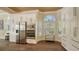 Bright kitchen with stainless steel appliances, wooden floors, and natural light from large windows at 7847 Chick Evans Pl, Sarasota, FL 34240
