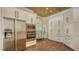 Spacious kitchen with stainless appliances, custom cabinets, and wood plank ceiling at 7847 Chick Evans Pl, Sarasota, FL 34240