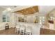 Bright kitchen featuring granite countertops, stainless appliances, custom cabinets, and breakfast bar at 7847 Chick Evans Pl, Sarasota, FL 34240