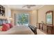 Bright main bedroom featuring neutral walls, shutters, and sliding glass doors to the pool at 7847 Chick Evans Pl, Sarasota, FL 34240