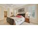 Bright main bedroom featuring neutral walls, shutters, and a ceiling fan at 7847 Chick Evans Pl, Sarasota, FL 34240